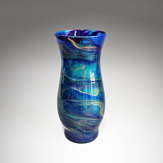 This abstract, peacock feather painted glass vase is the perfect accent piece for any décor. Unique and one-of-a-kind, you're sure to get many compliments on this unique design. Done in a striking mix of metallic teal, cobalt blue, purple and gold,