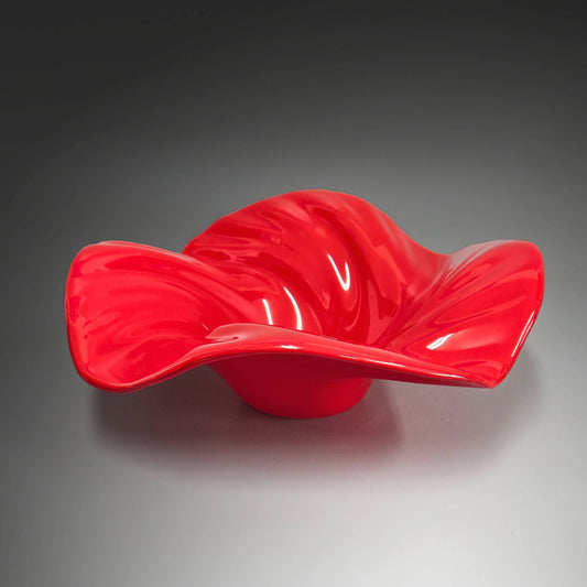 This beautiful glass wave bowl is done in striking shade of bright scarlet red.  It's done in an opaque glass which lets the light play off it beautifully.