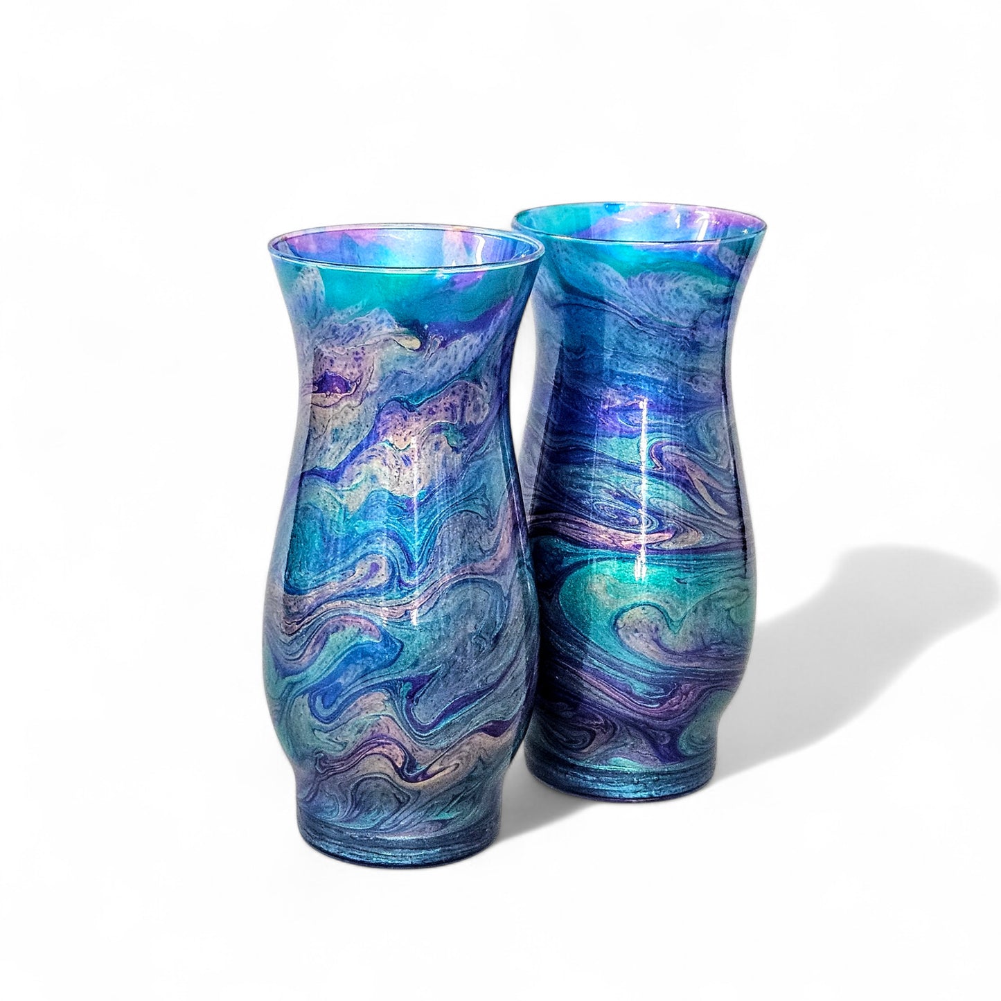 This abstract, peacock feather painted glass vase is the perfect accent piece for any décor.
