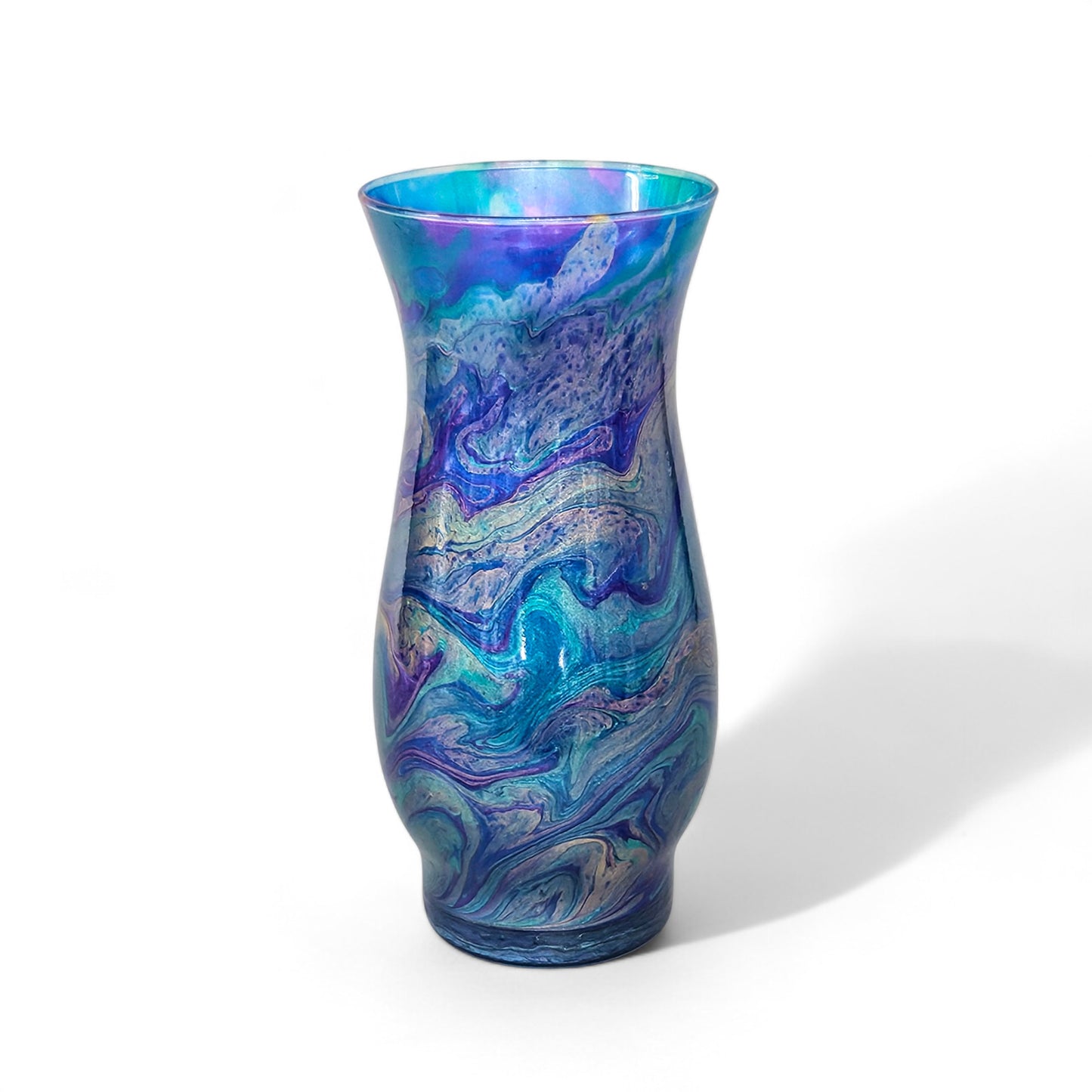 This abstract, peacock feather painted glass vase is the perfect accent piece for any décor.