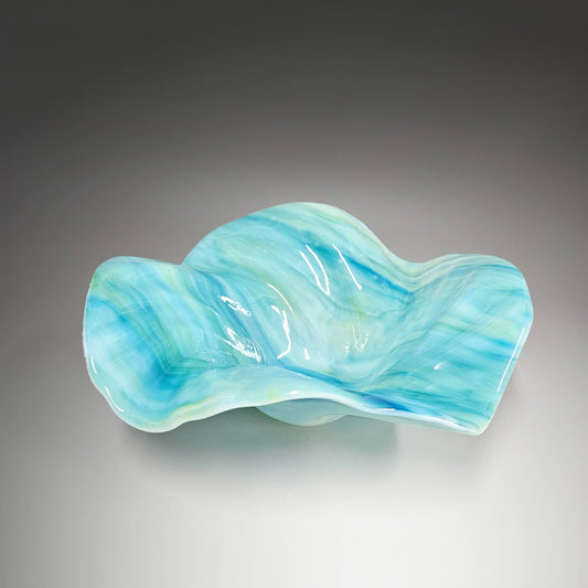 This stunning piece of sculptured glass captures the essence of the sea in every ripple and wave. Handcrafted in Cincinnati, Ohio, this exquisite bowl will elevate your beach house décor to a whole new level.