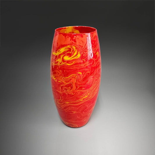 Flowers don't last; hand painted vases do. This 10 inch tall, abstract, glass flower vase is the perfect accent piece for any décor. Unique and one-of-a-kind, you're sure to get many compliments on this stand-out piece of art. Done in a striking mix of red, orange and yellow, 