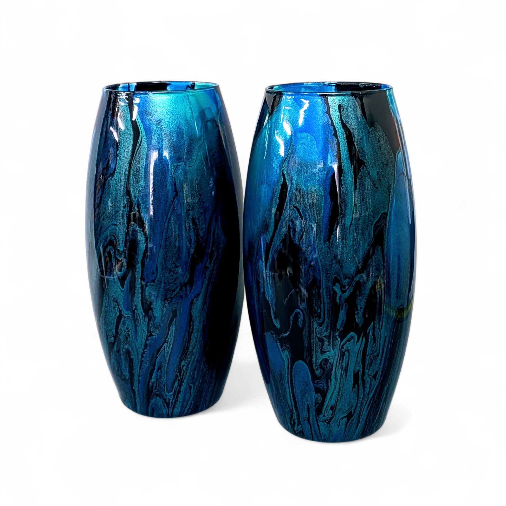 Two blue glass vases with marbled design on a white background