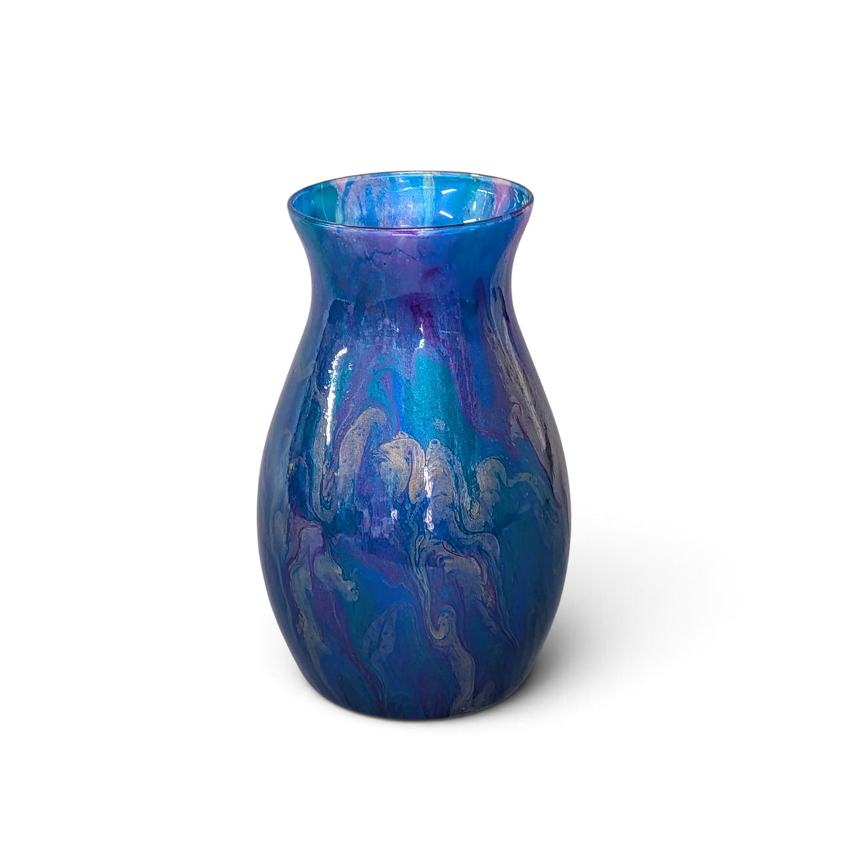 A small glossy glass vase with a flared rim, featuring a marbled swirl pattern of blue, purple, and teal on a white background.